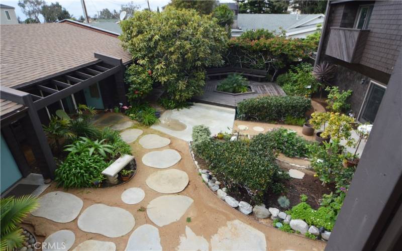 The common courtyard for the five condo units in this Chris Abel designed complex.  Chris respected nature and used it to accent the charm of his designs.