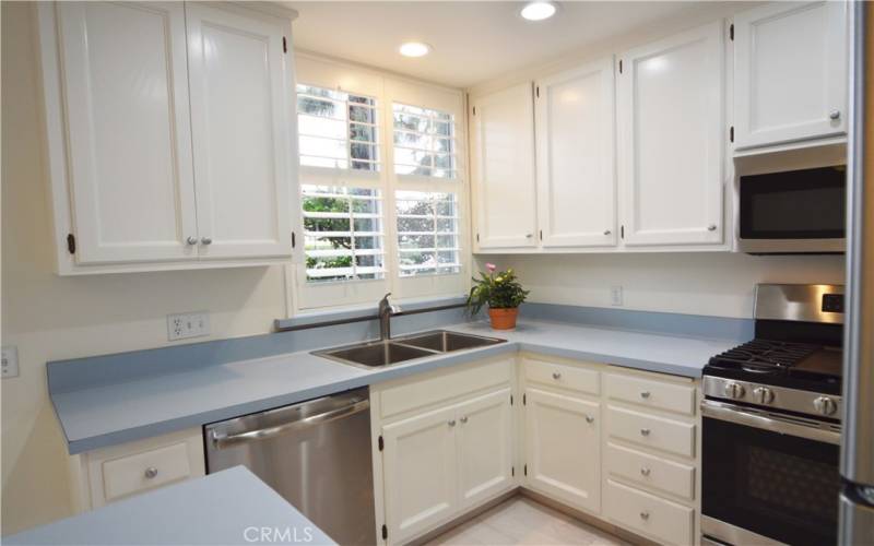 The kitchen looks onto the small private patio...easy access to outdoor dining.