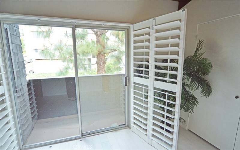 The small balcony off the second bedroom looks toward the hills.