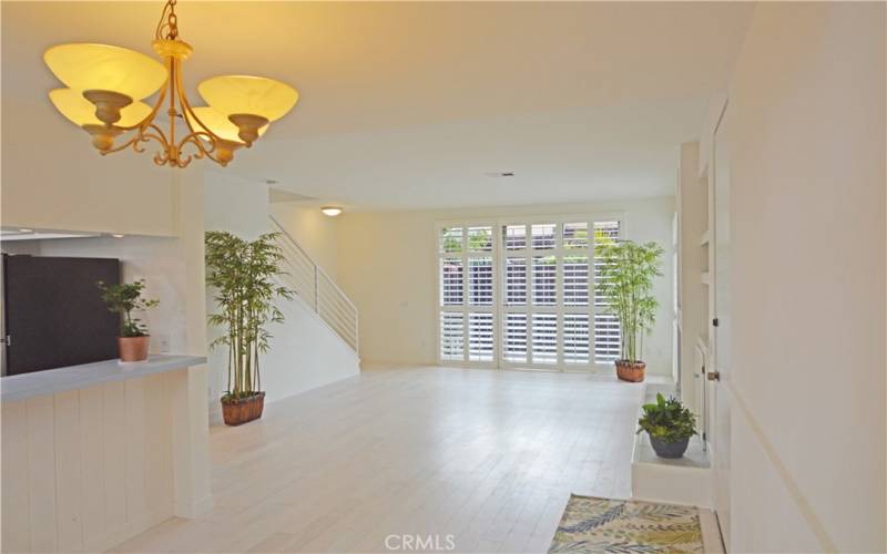 At the far end of the living room, more sliding glass doors open to the large private patio.