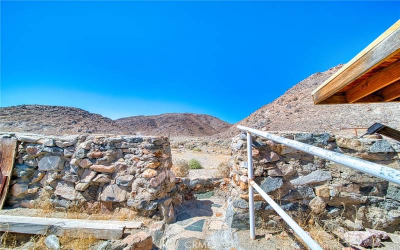 View the the beautiful mountains from the stone fence in the backyard