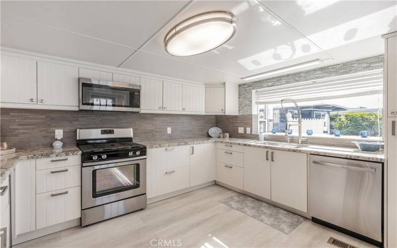 Kitchen with Bay window looking out to Tropical yard.