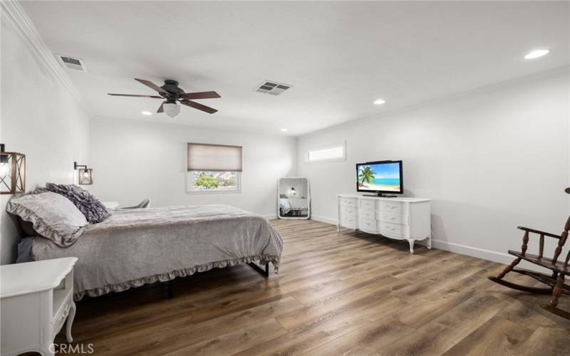 Primary bedroom with ceiling fan.