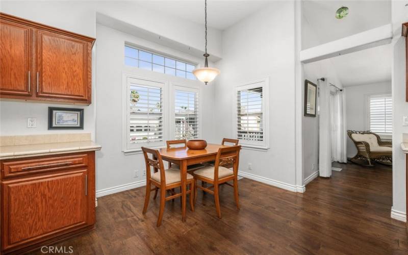 Breakfast nook area, window coverings are wood plantation shutters.