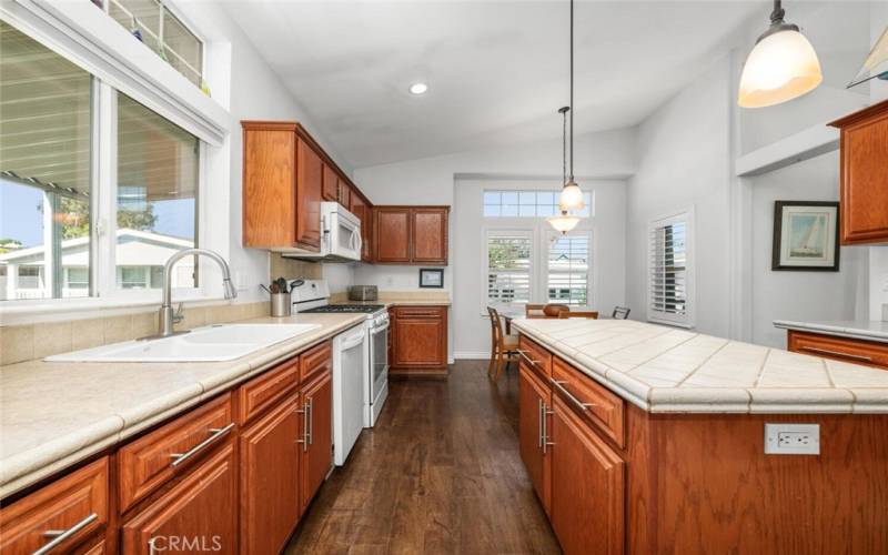 High ceilings in kitchen combined with multiple windows work together to provide a bright and open and spacious feeling.