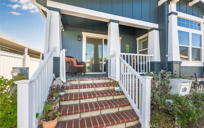 Front porch with vinyl handrails and beautiful brick steps.