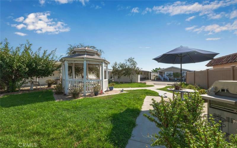 This unique common area outdoor picnic area with gas BBQ is situated directly behind the home. There are also several convenient parking spaces nearby for guests to use.