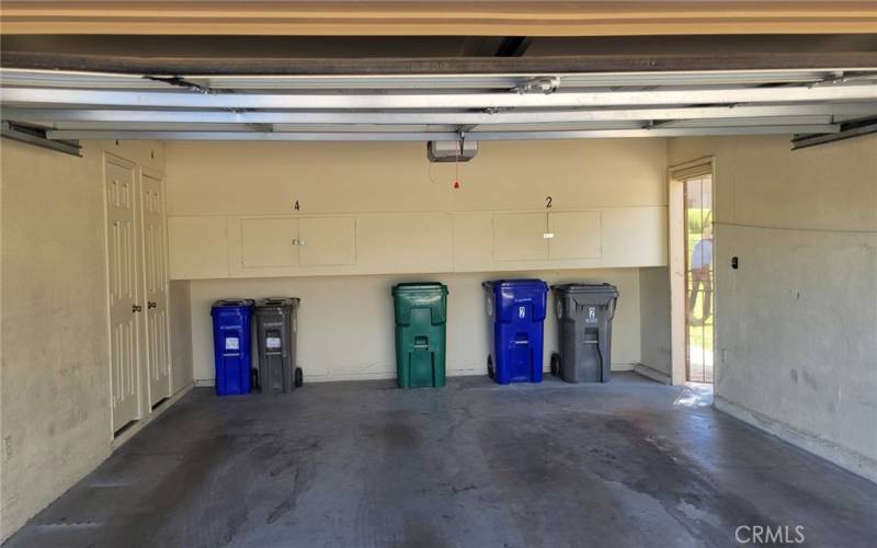 Shared Double Garage has Storage Cabinet and Spacious Storage Room thru Doorway on Left