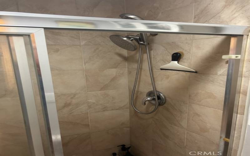 Primary Bathroom with Tile Throughout and Rainfall Showerhead