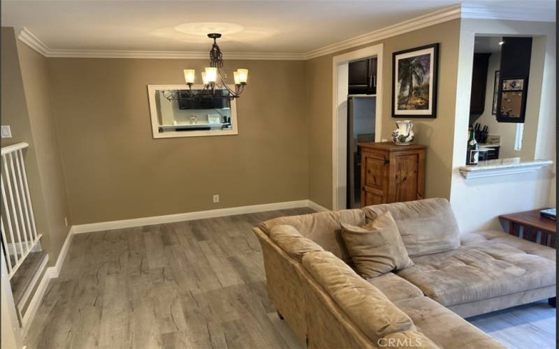 Entry Way Leads into Open Living Room and Dining Room Area with New Vinyl Flooring