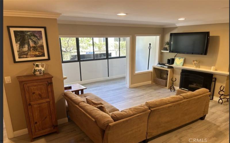 Living Room with Fireplace and View of Enclosed Patio