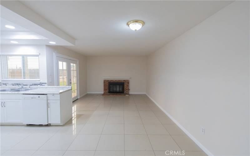 Fireplace located in dining area with French doors leading to backyard.