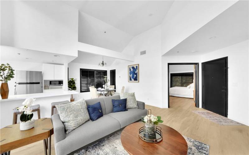 The large family room is enhanced by plantation shutters and flows seamlessly into a newly remodeled kitchen boasting sleek countertops and soft-close drawers.