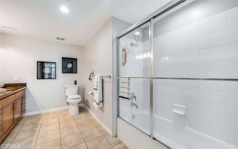 The Primary Bath sports a sizeable tub-shower with oversized white tile.