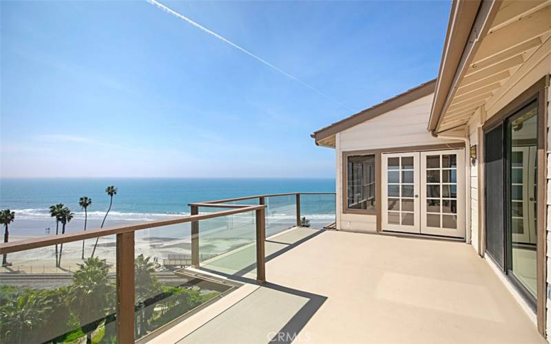 Looking from Primary bedroom deck to living room deck.  Large space for entertaining.