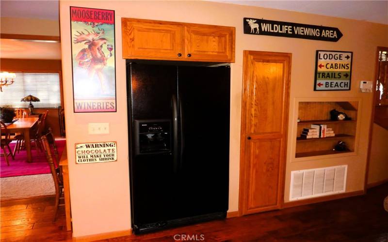 On the opposite side of the kitchen from the sink is the built in refrigerator and small pantry.