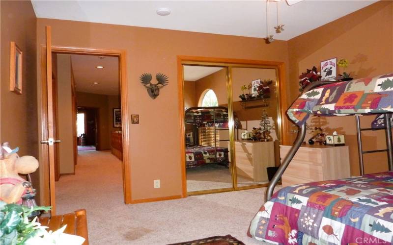 Bedroom #3 has mirrored closet doors and a ceiling  fan.