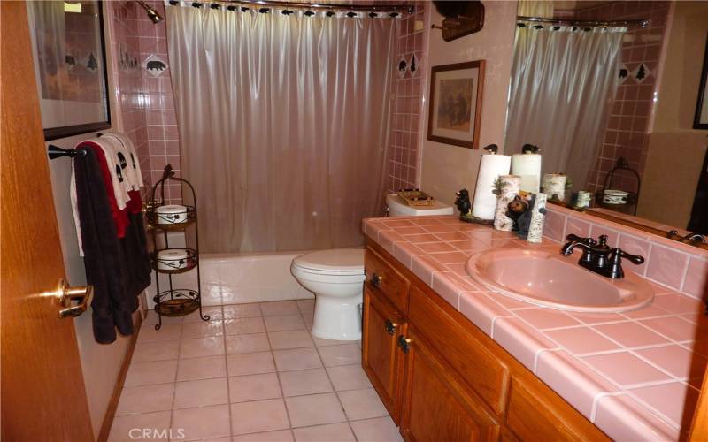 Next door to the laundry area is the full bath that services the 3 bedrooms on the upper level.