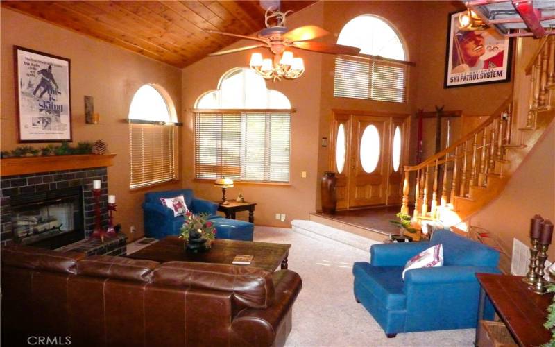 From the dining room, you can overlook the sunken living room and see all the way to the front door.