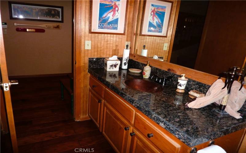 Big granite countertop in the bathroom on the main level.