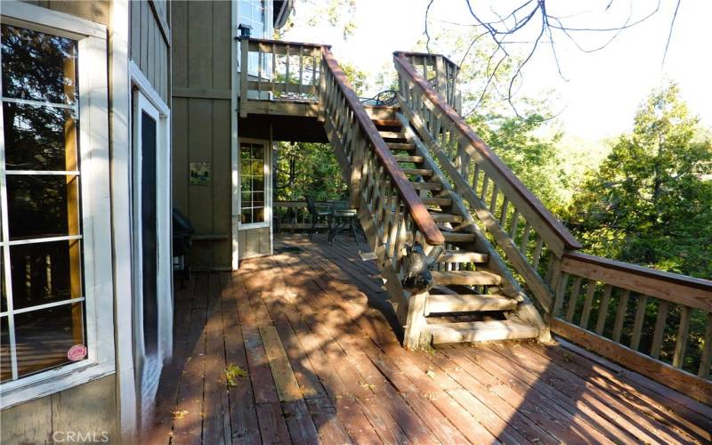 The main deck runs across most of the rear of the home. You have access to the master deck above and the yard below from this deck.