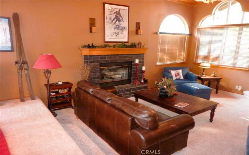 The sunken living room also features its own fireplace.