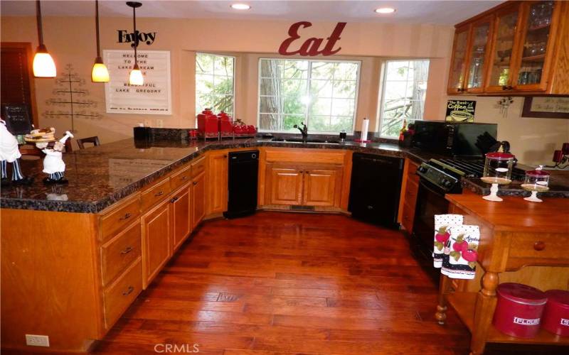 The U-shaped kitchen is fully equipped with everything you need. The double sink has a bay window to allow natural light inside while you're doing the dishes.