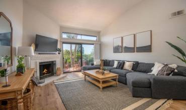 Spacious living room filled with light with a large patio through the sliders.