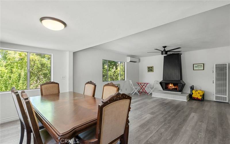 Main house Dining and Living Room. The fire inside the fireplace is Virtually Staged.