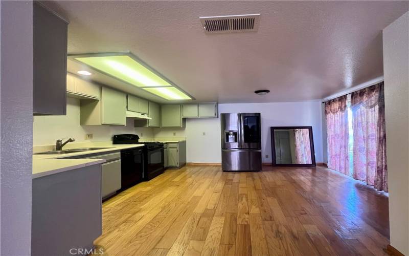 Open kitchen with entrance to backyard