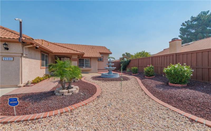 Front landscape design with water fountain