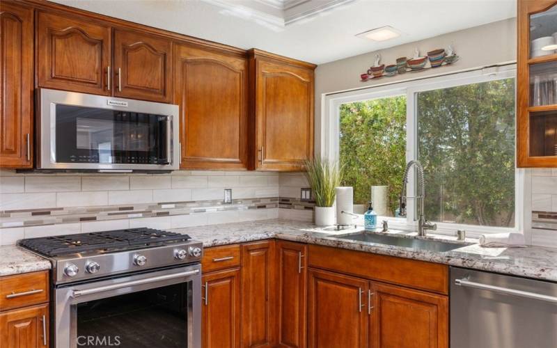 The window above the sink allows a flood of natural light a view of the spacious side yard.