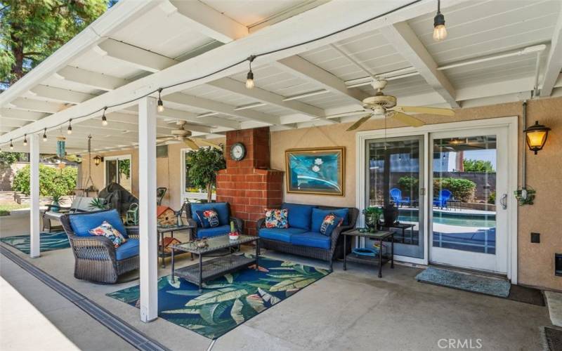 Inviting rear patio is spacious enough for multiple conversation areas and overlooks the lawn and the pool/spa.