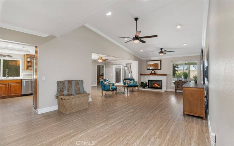 Remodeled open floorplan with vaulted ceilings, crown moulding  luxury vinyl flooring, and recessed lighting