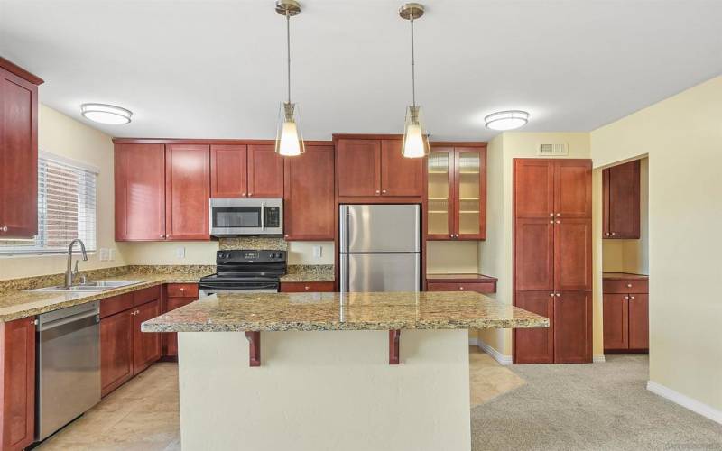 In unit stack laundry hookups are located inside the tall cabinet to the right