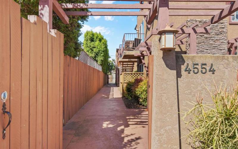 Gated entry with wood pergola detailing