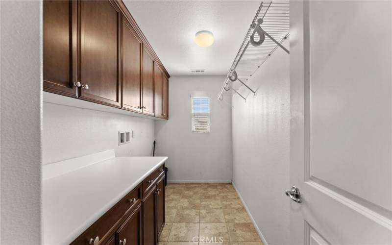 Large laundry room with additional storage space.