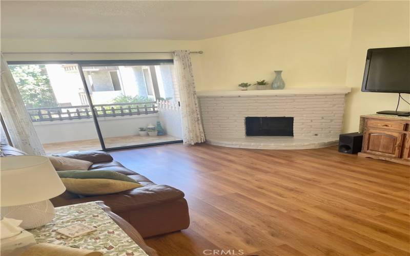 living room with fireplace and balcony