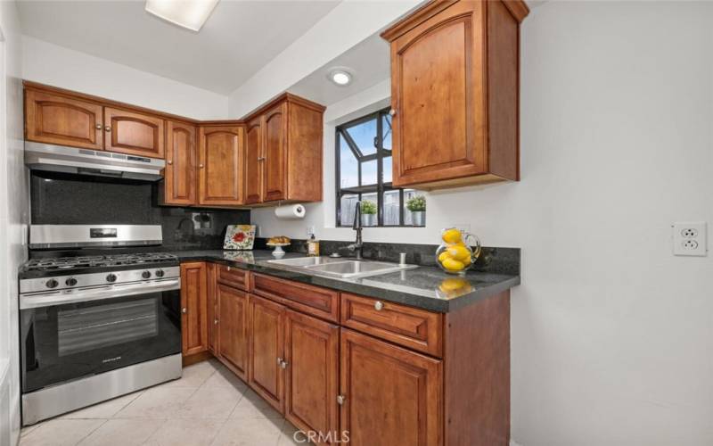 Kitchen upgrades include new stove, range hood, stone counter-tops, stainless-steel sink and fixtures.