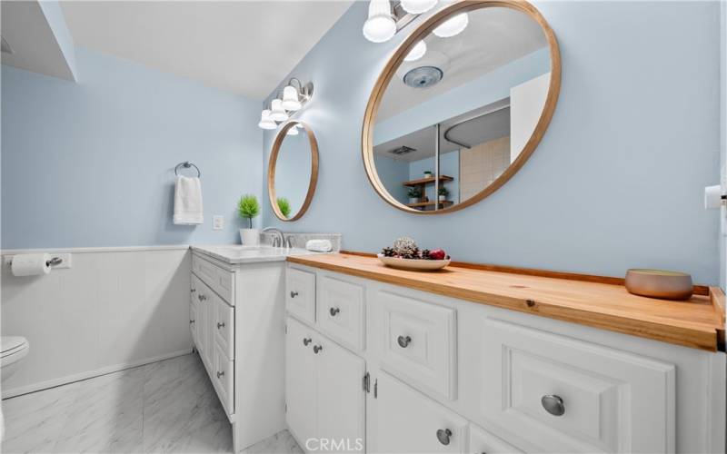 Upgraded main bathroom with marble vanity top and custom wood counter.