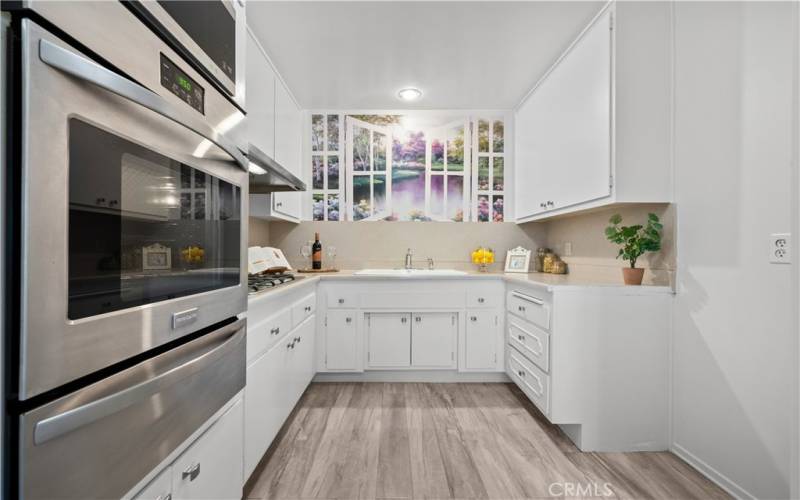 Galley kitchen w/built-in gas range and oven.