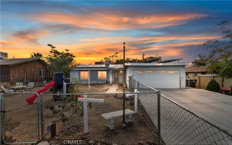 Front of Home with Fenced Yard and 2-Car Garage