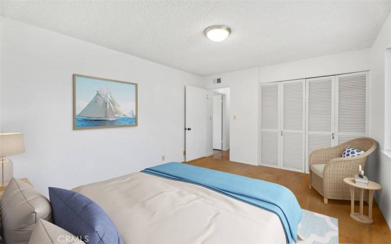 Secondary bedroom with louvered closet doors. VIRTUALLY STAGED