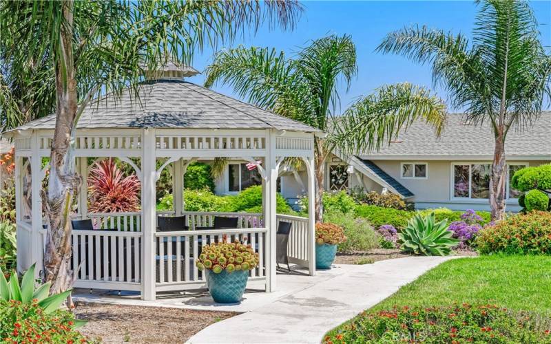 Common area courtyard features a pretty gazebo and tropical native landscape.