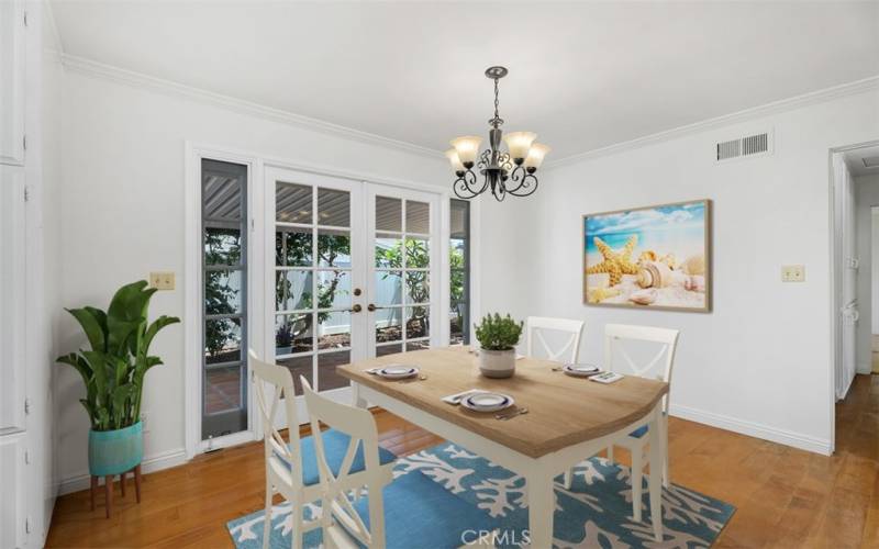 Dining area with pretty french doors leading to large back patio. VIRTUALLY STAGED