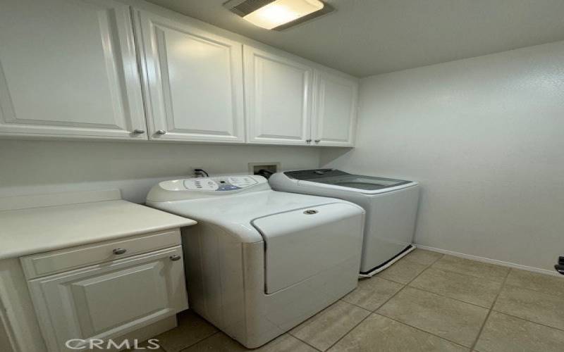 Large laundry room with additional storage