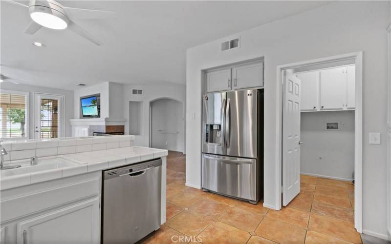 Shows laundry room off of kitchen