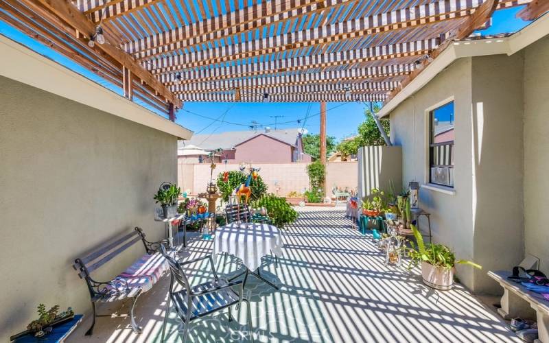 Lovely covered patio between garage and master bedroom.