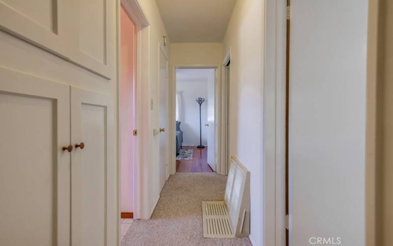 Both a coat closet and linen storage in hallway.