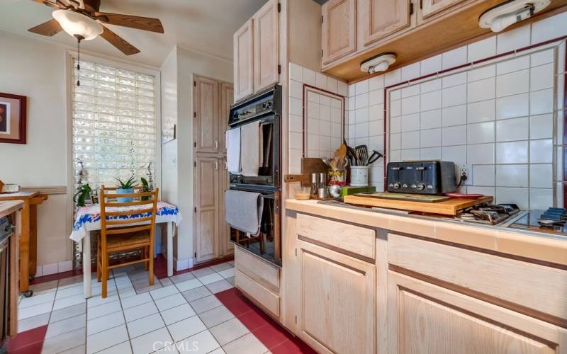 Gas stove, double ovens. Lots of natural light coming in.